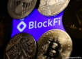 BlockFi logo displayed on a phone screen and representaation of cryptocurrencies are seen in this illustration photo taken in Krakow, Poland on November 14, 2022. (Photo by Jakub Porzycki/NurPhoto)